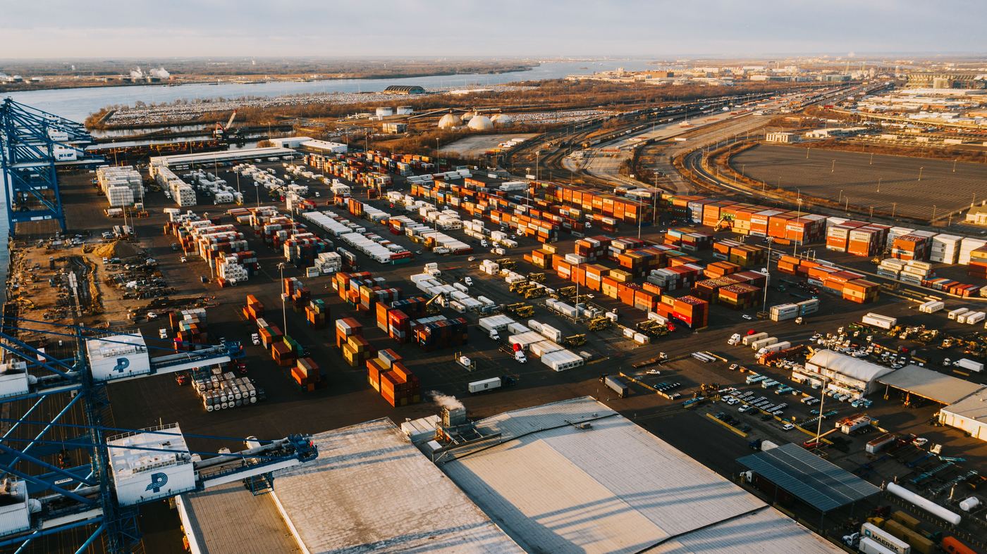 Aerial view of a busy container port and rail terminal